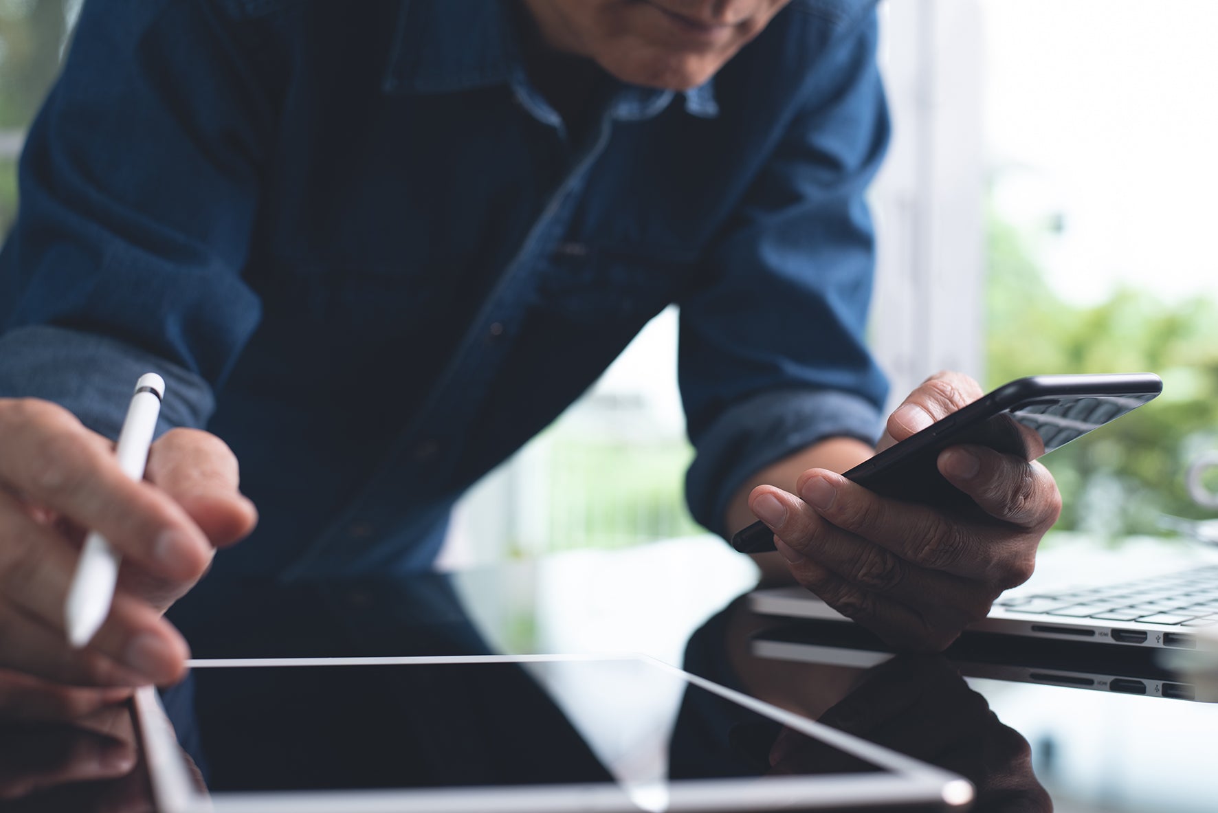 Person holding a smartphone with a blurred background