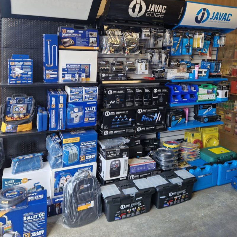 Display of automotive parts and tools with JAVAC branding in a store setting.