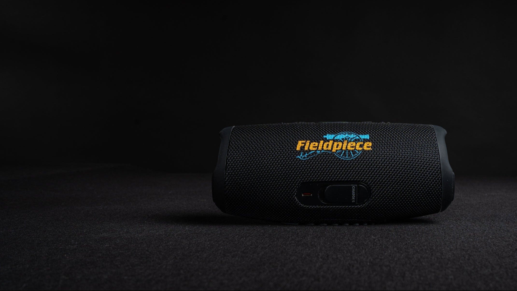 Black speaker with Fieldpiece logo on a dark background