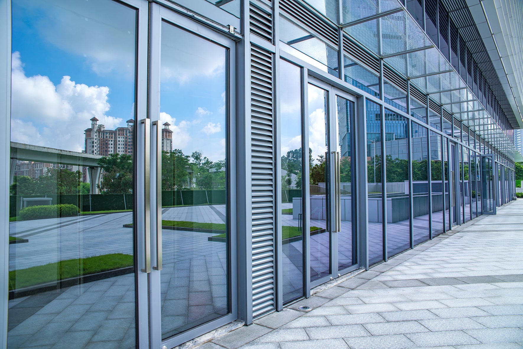 Glass building with reflections of the street