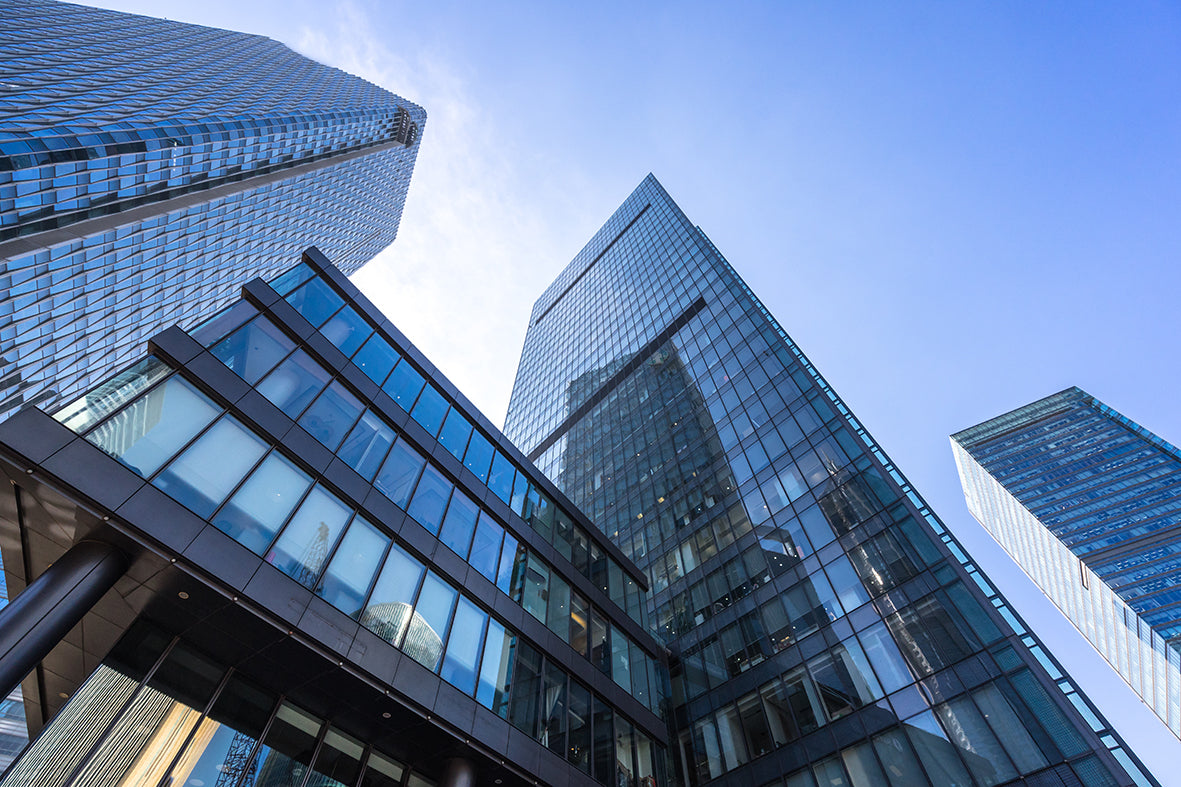 High-rise glass office buildings in city with blue sky