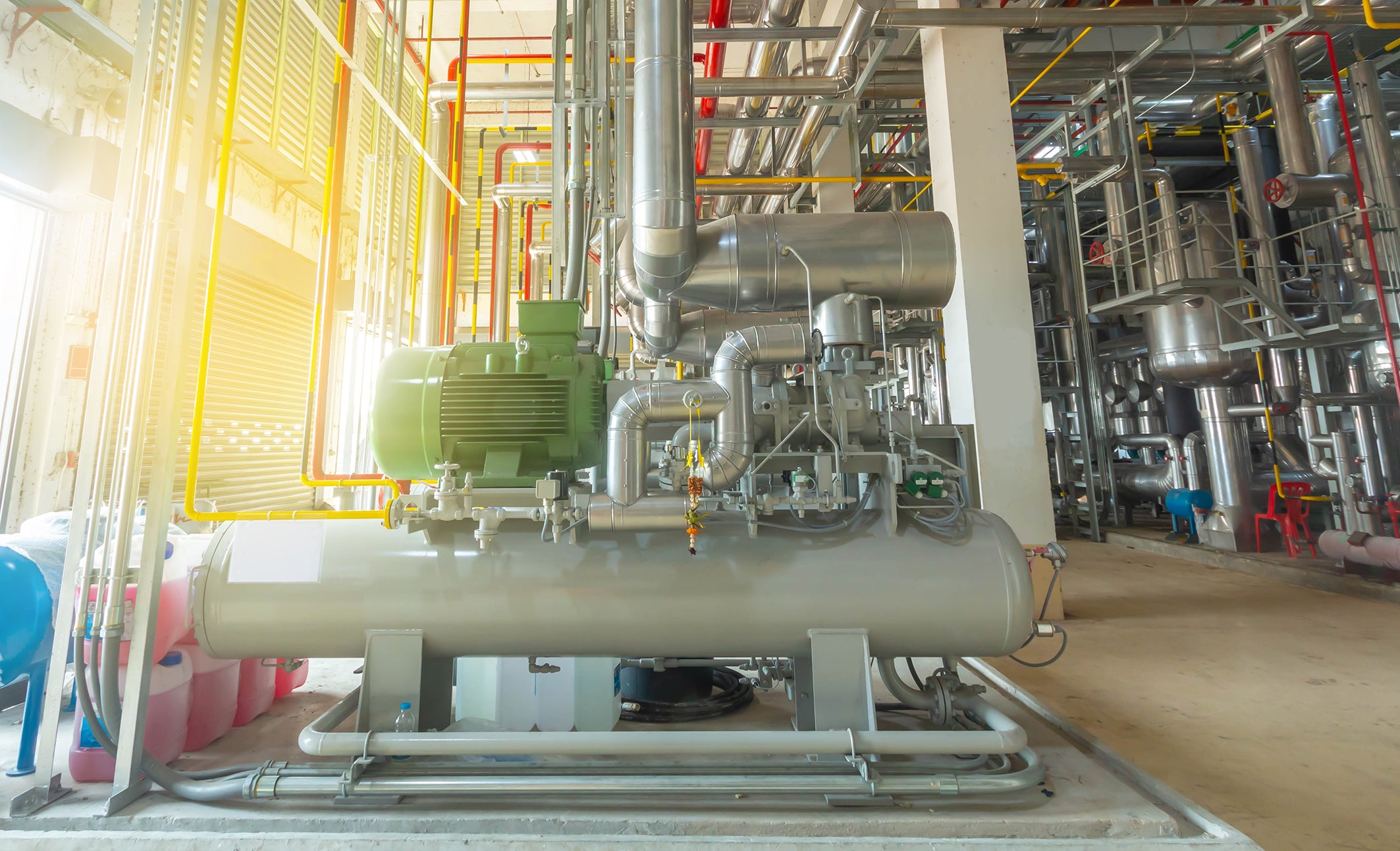 Plant room with heavy HVAC products including a green Bitzer product.